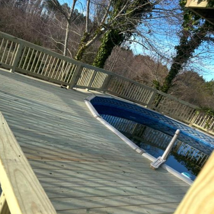 Bright white kitchen with island, cabinets, stainless steel appliances, and hardwood floors.