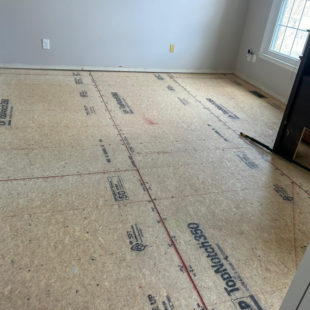 Room with exposed OSB subfloor ready for new flooring installation.