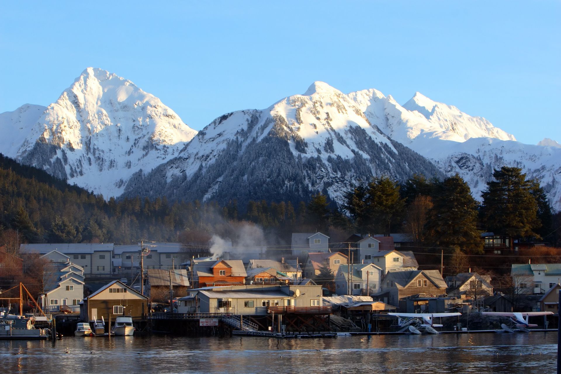 A small town with snowy mountains in the background
