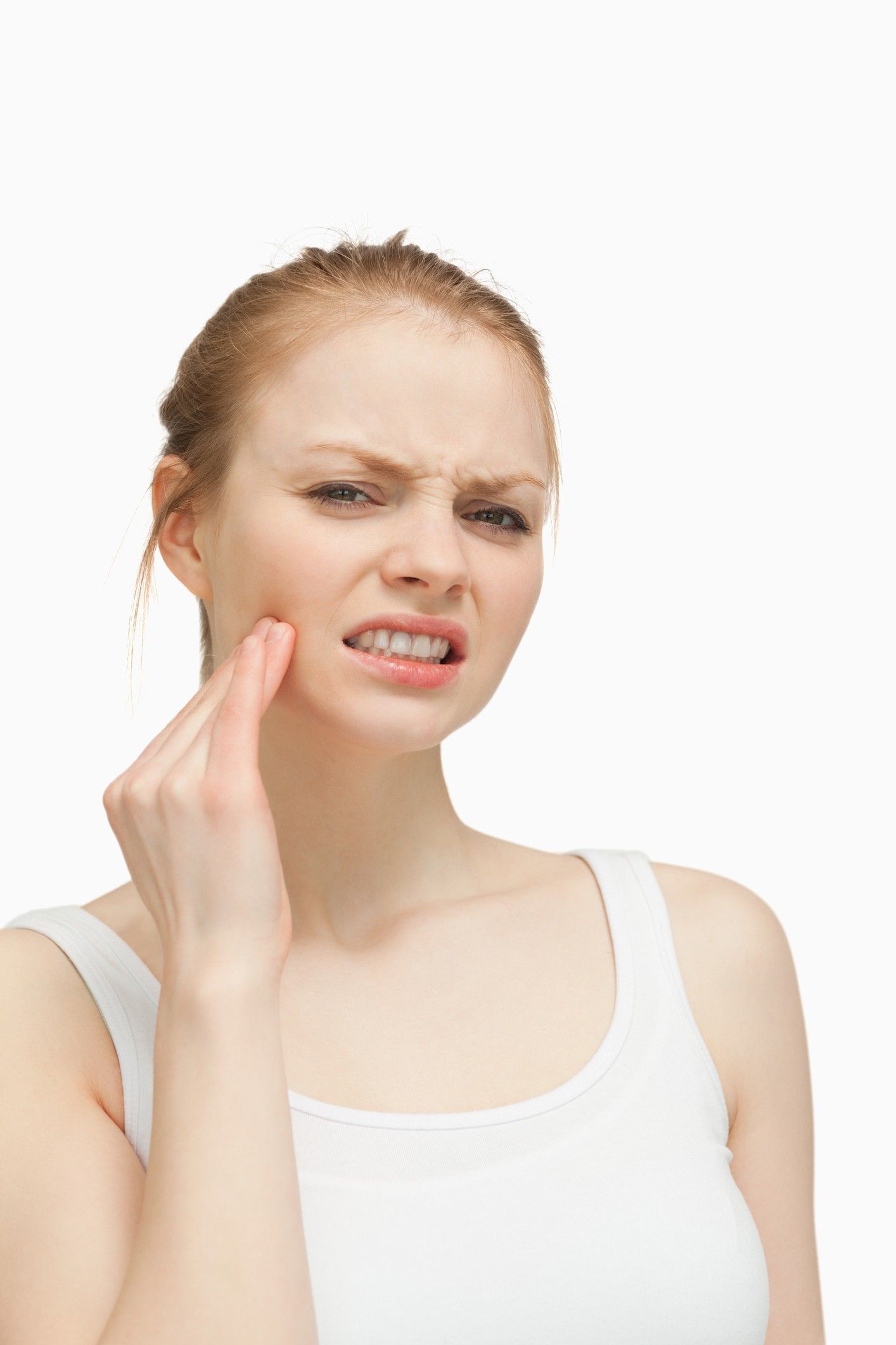 A woman is holding her face in pain because of a toothache.