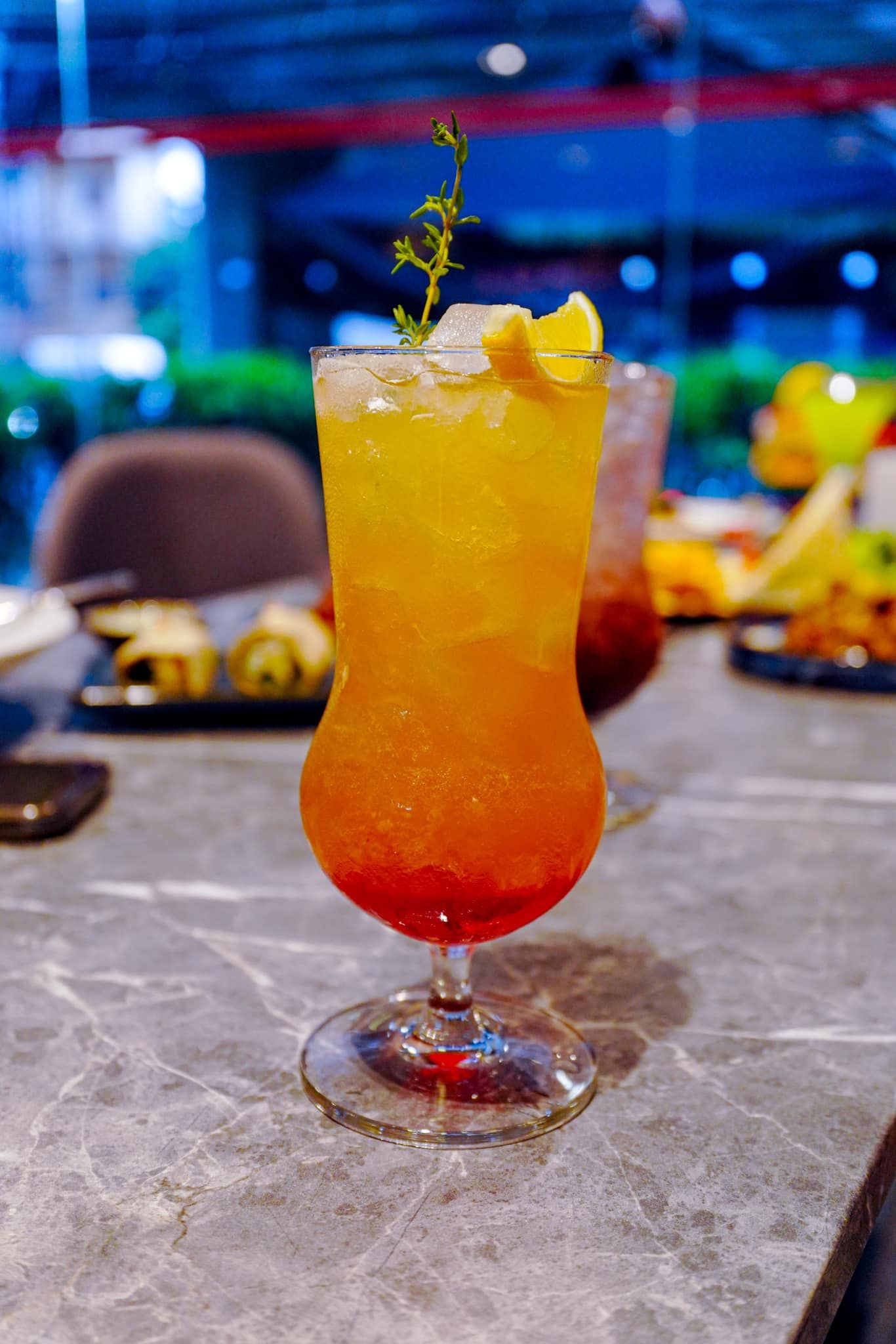A close up of a drink in a glass on a table.