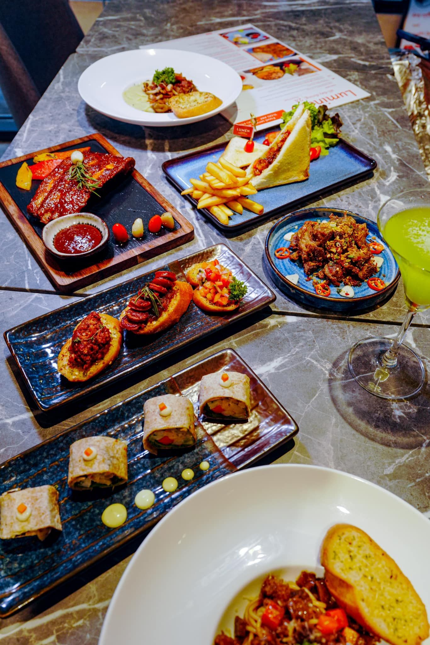 A table topped with plates of food and drinks.