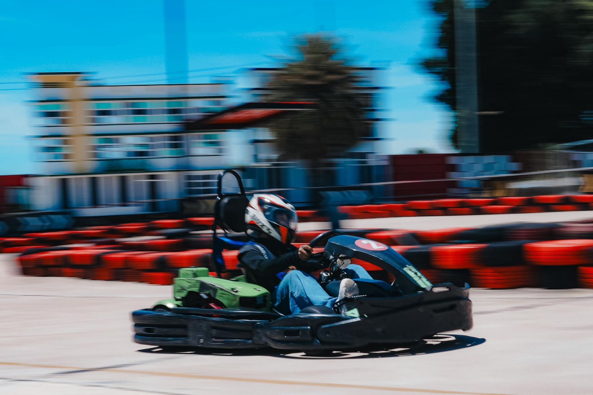 A person is riding a go kart on a track.