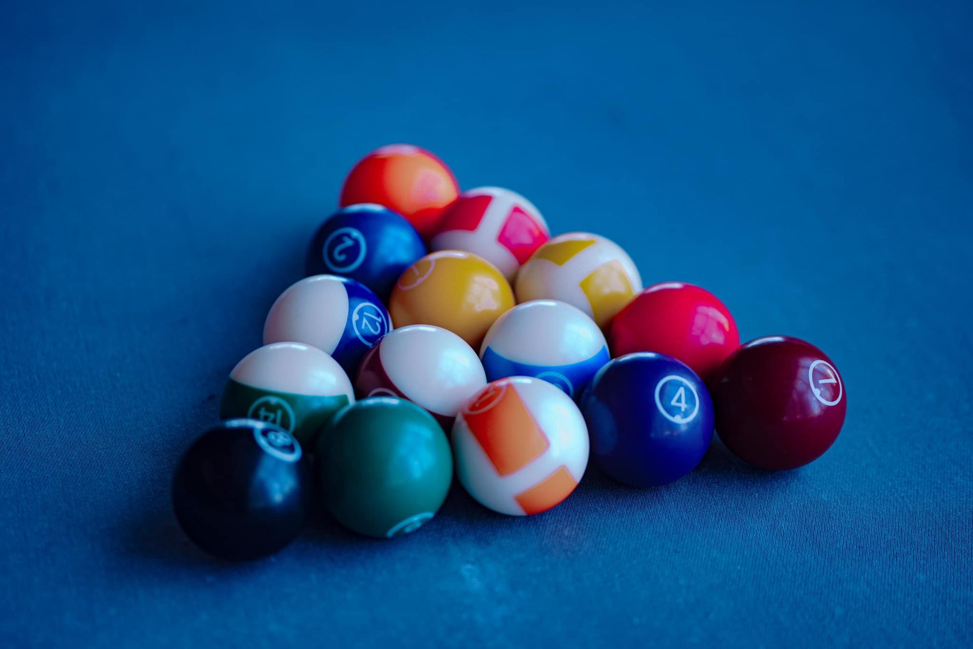 Pool balls arranged in a triangle on a pool table