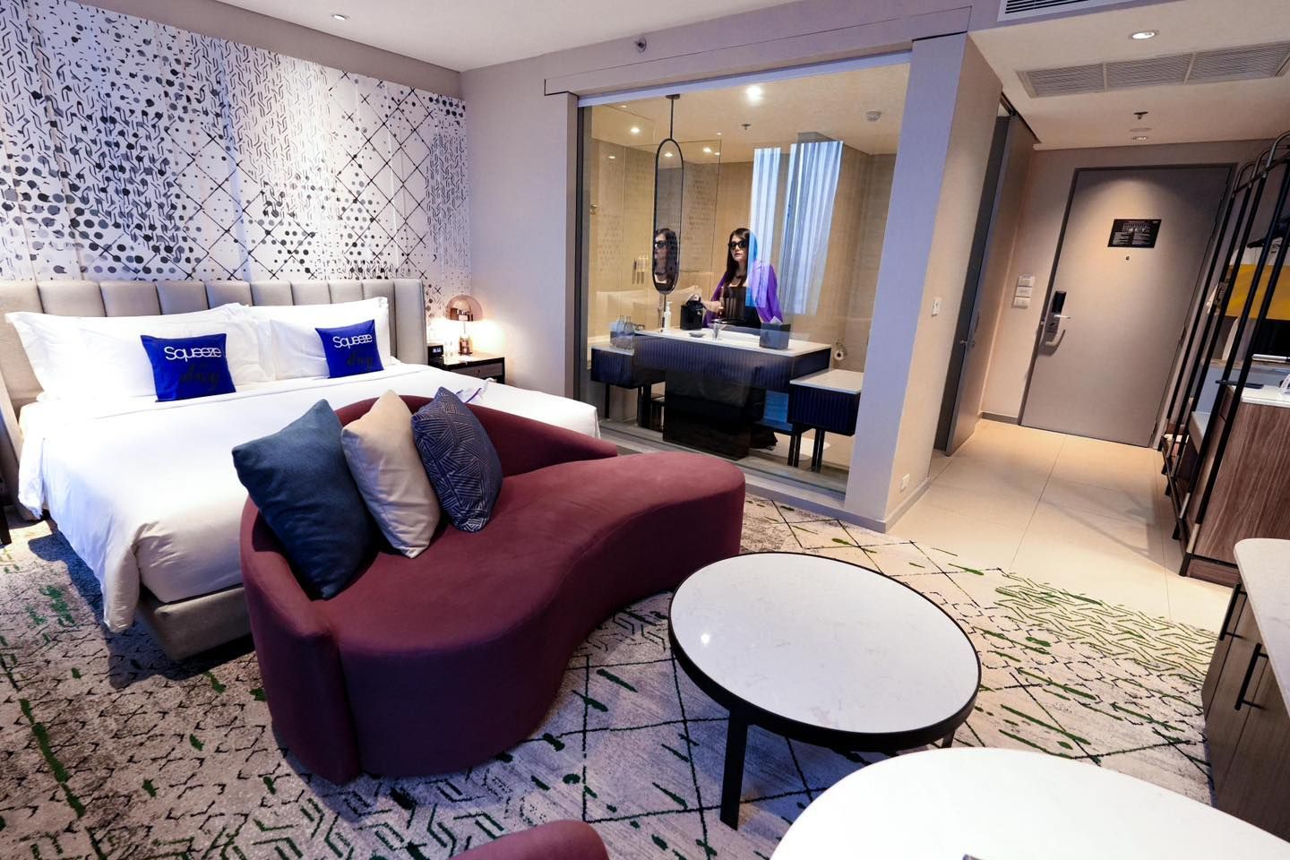 A hotel room with a couch and a table in Avani Sukhumvit Bangkok