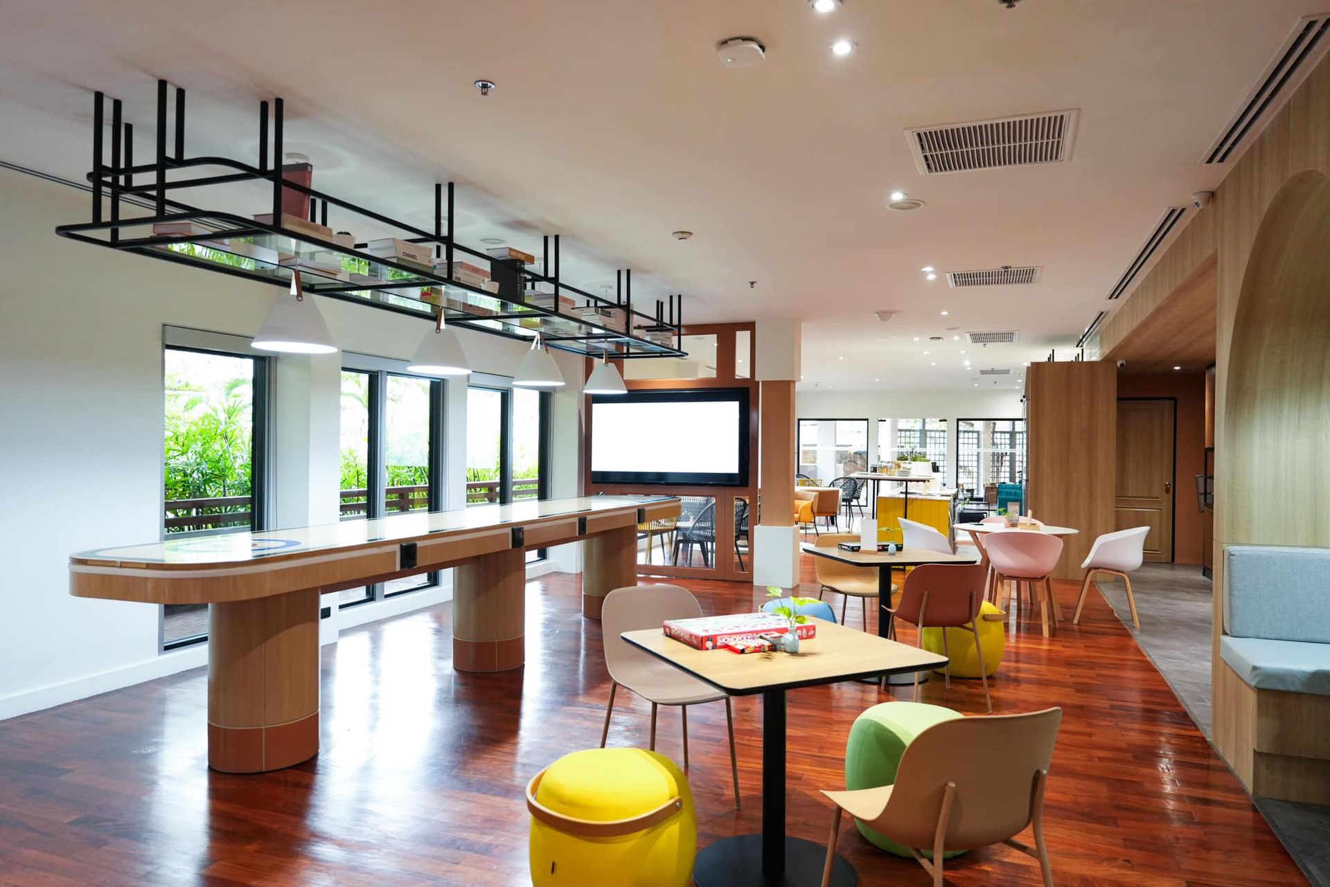 A large room with tables and chairs in it.