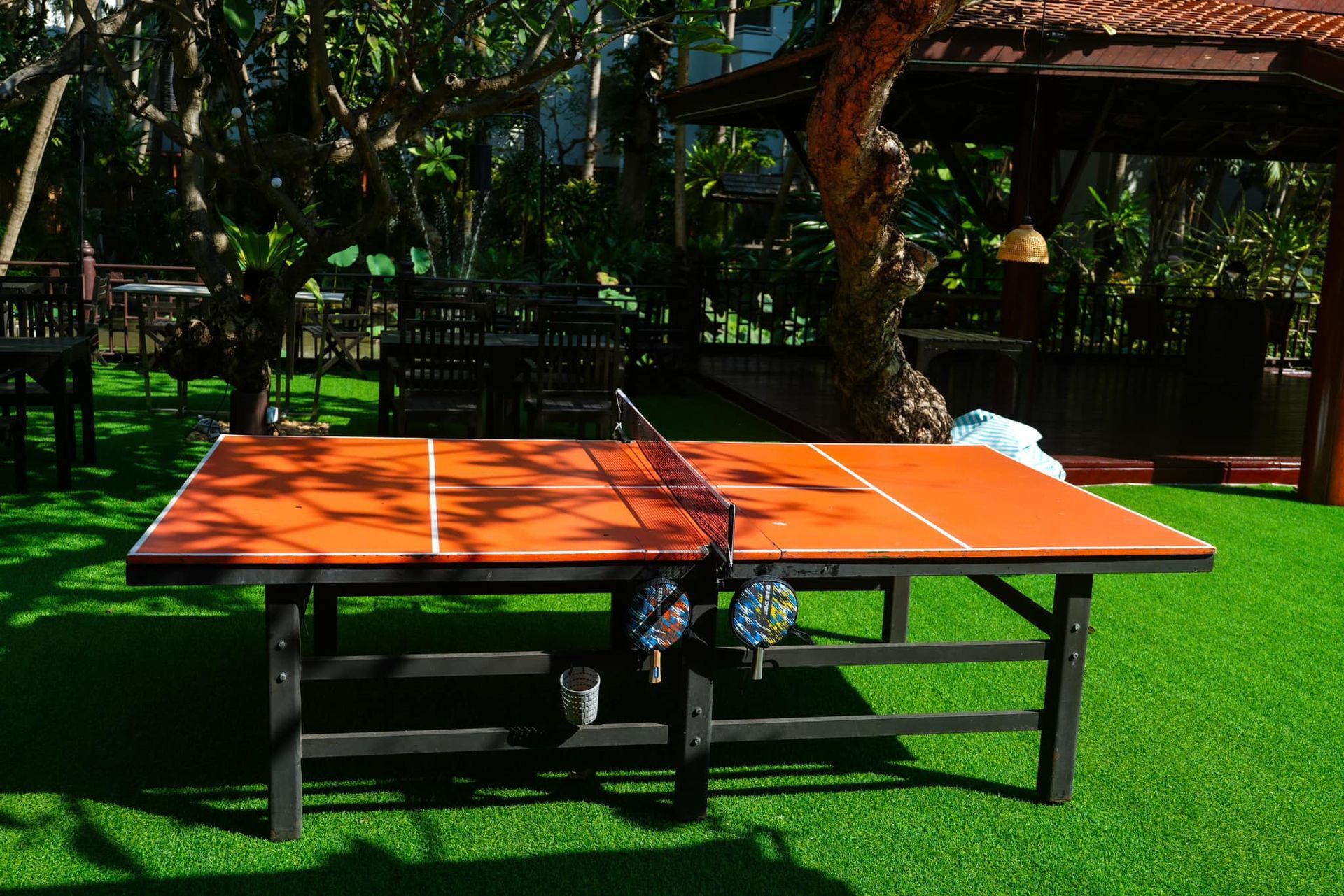 A ping pong table is sitting on top of a lush green lawn.