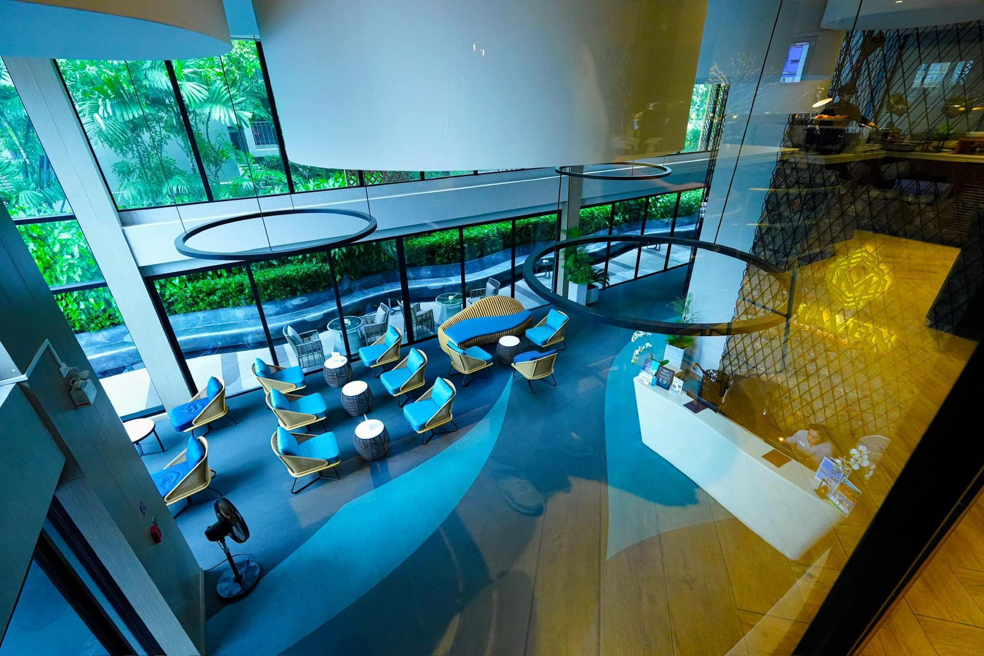 An aerial view of a hotel lobby with chairs and tables