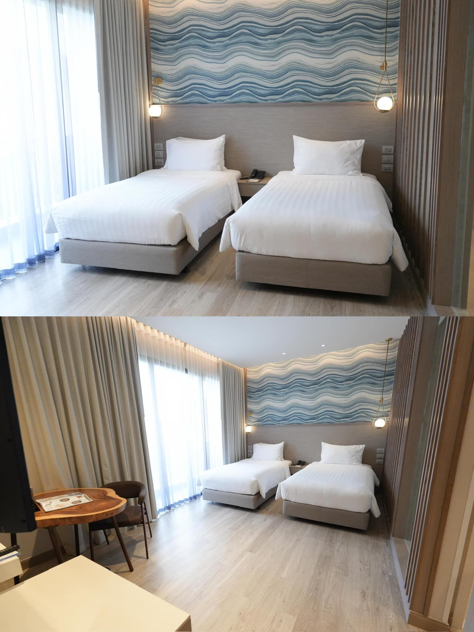 A hotel room with two beds and a table.