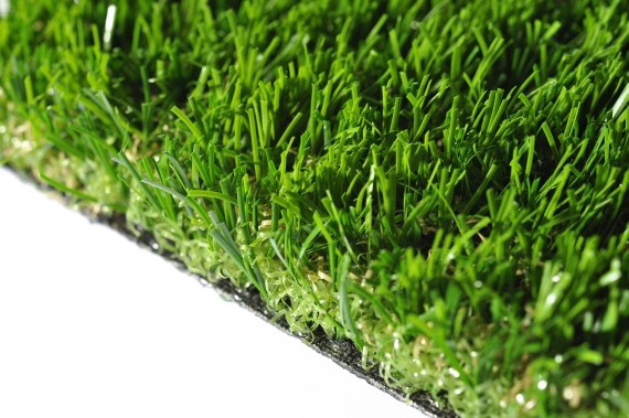 Extreme close-up of individual synthetic grass blades and thatch.