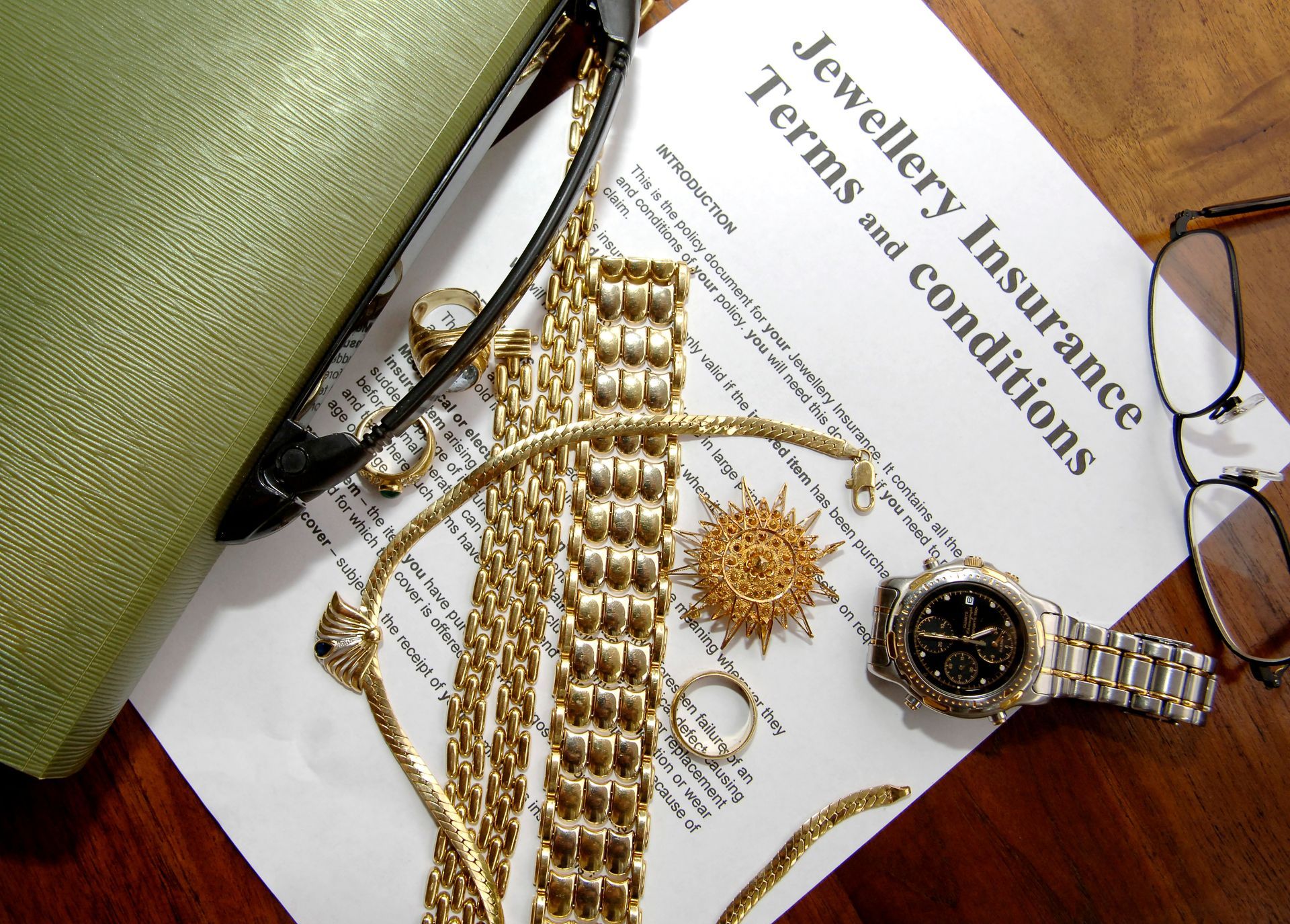 A watch is on top of a jewellery insurance form