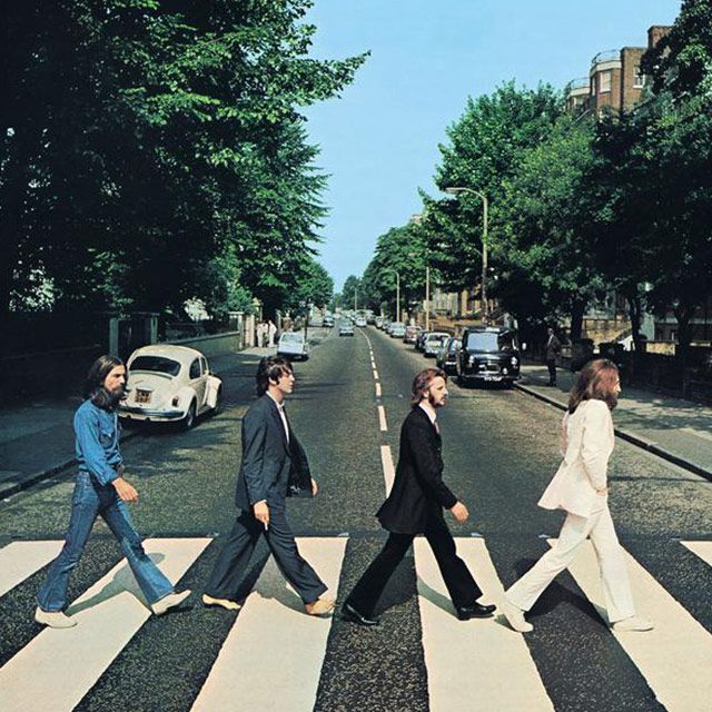 A group of people crossing a street on a zebra crossing