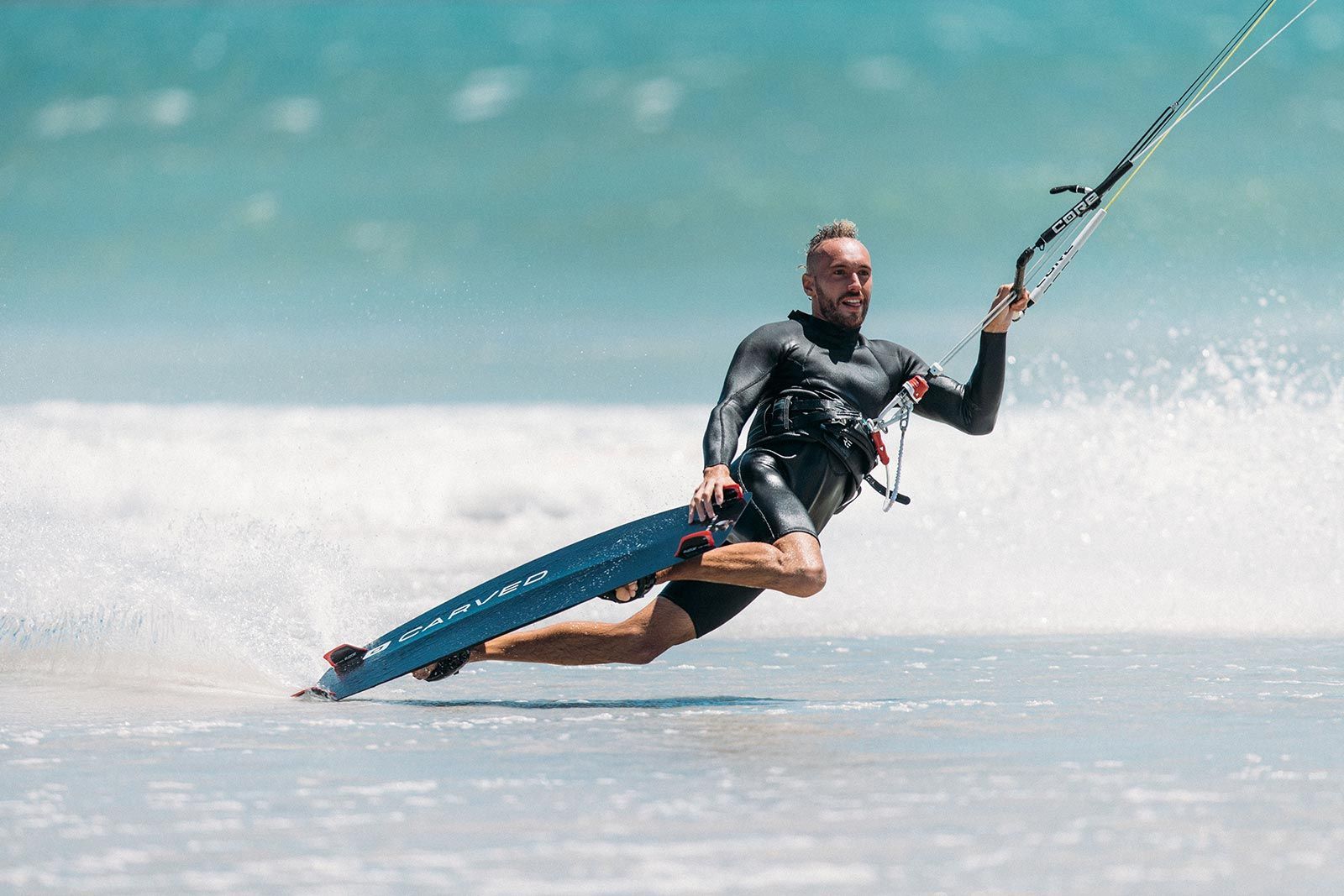 A man is flying through the air while riding a surfboard in the ocean.