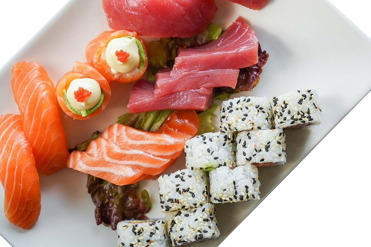 Ein weißer Teller mit verschiedenen Sushi und Rollen