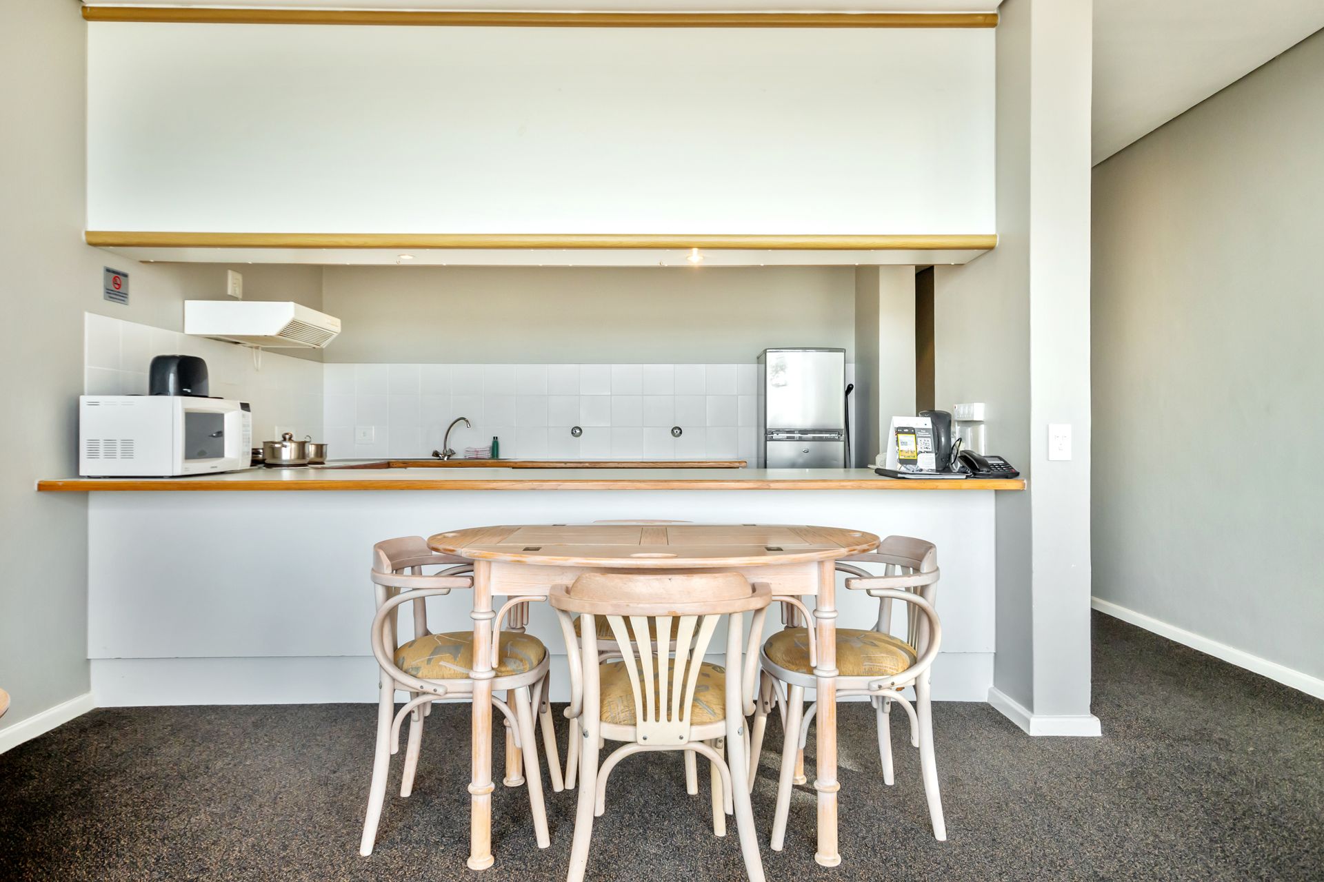 A kitchen with a table and chairs in it