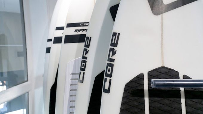 Two white surfboards with the word core on them