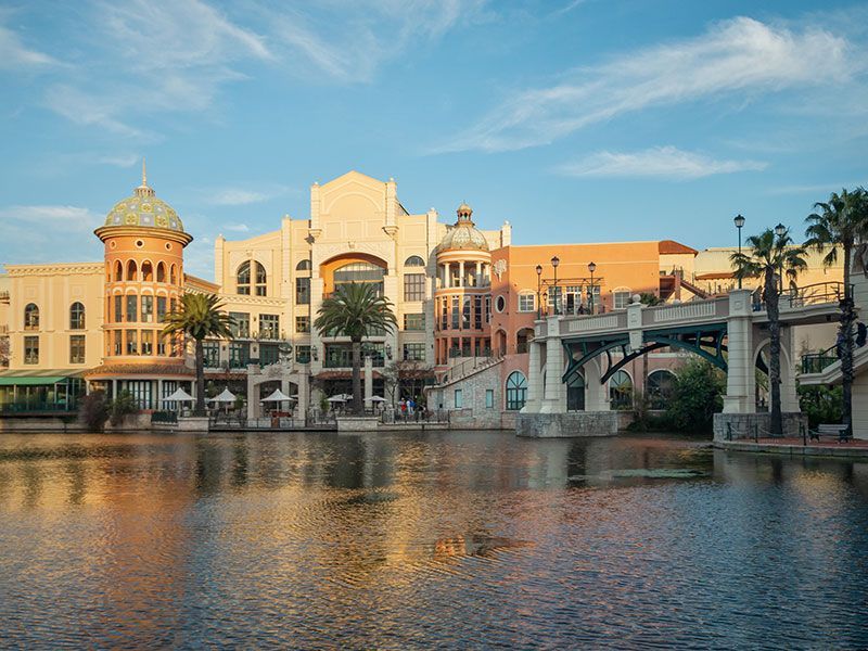 A bridge over a body of water with buildings in the background.