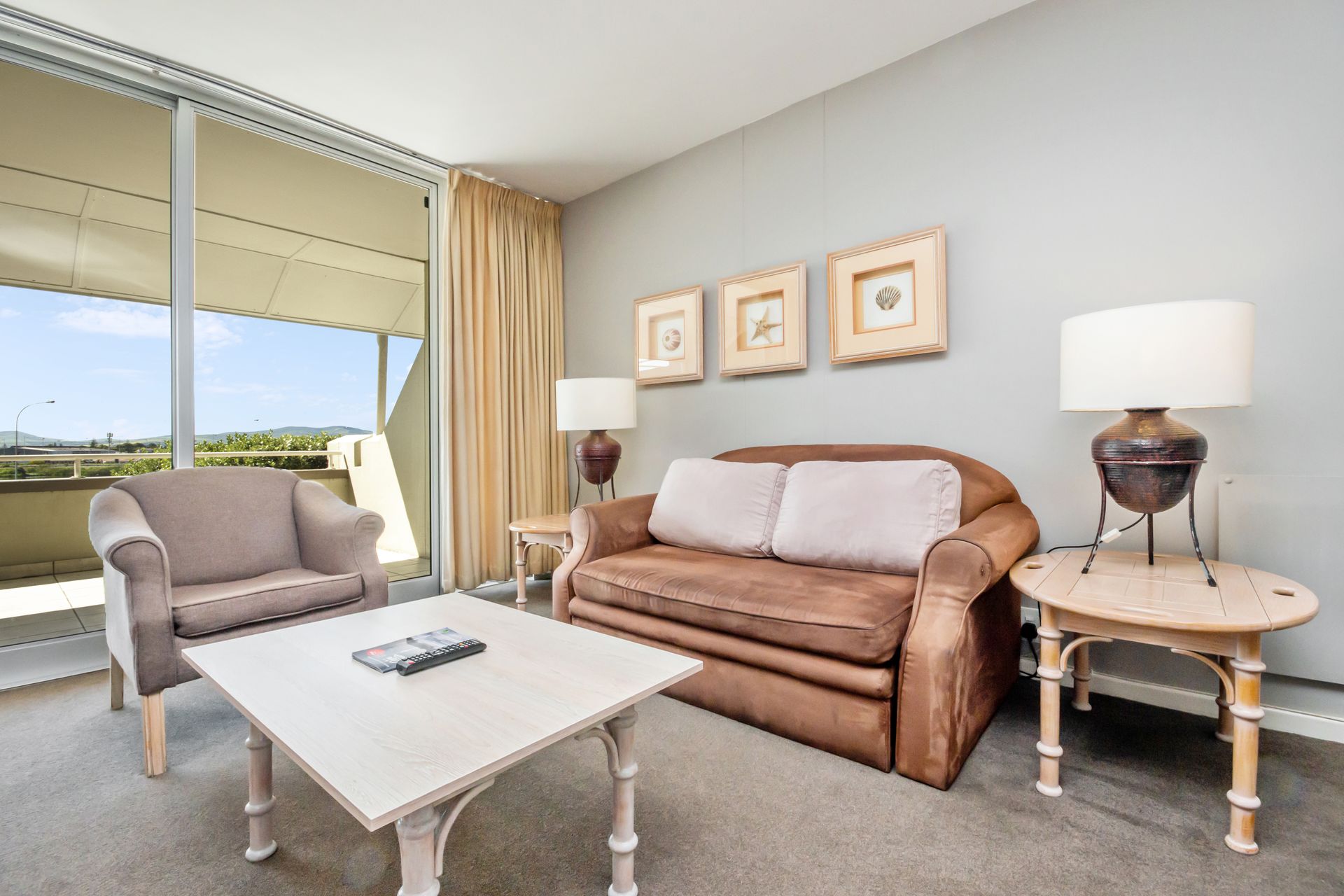 A living room with a brown couch and a white coffee table