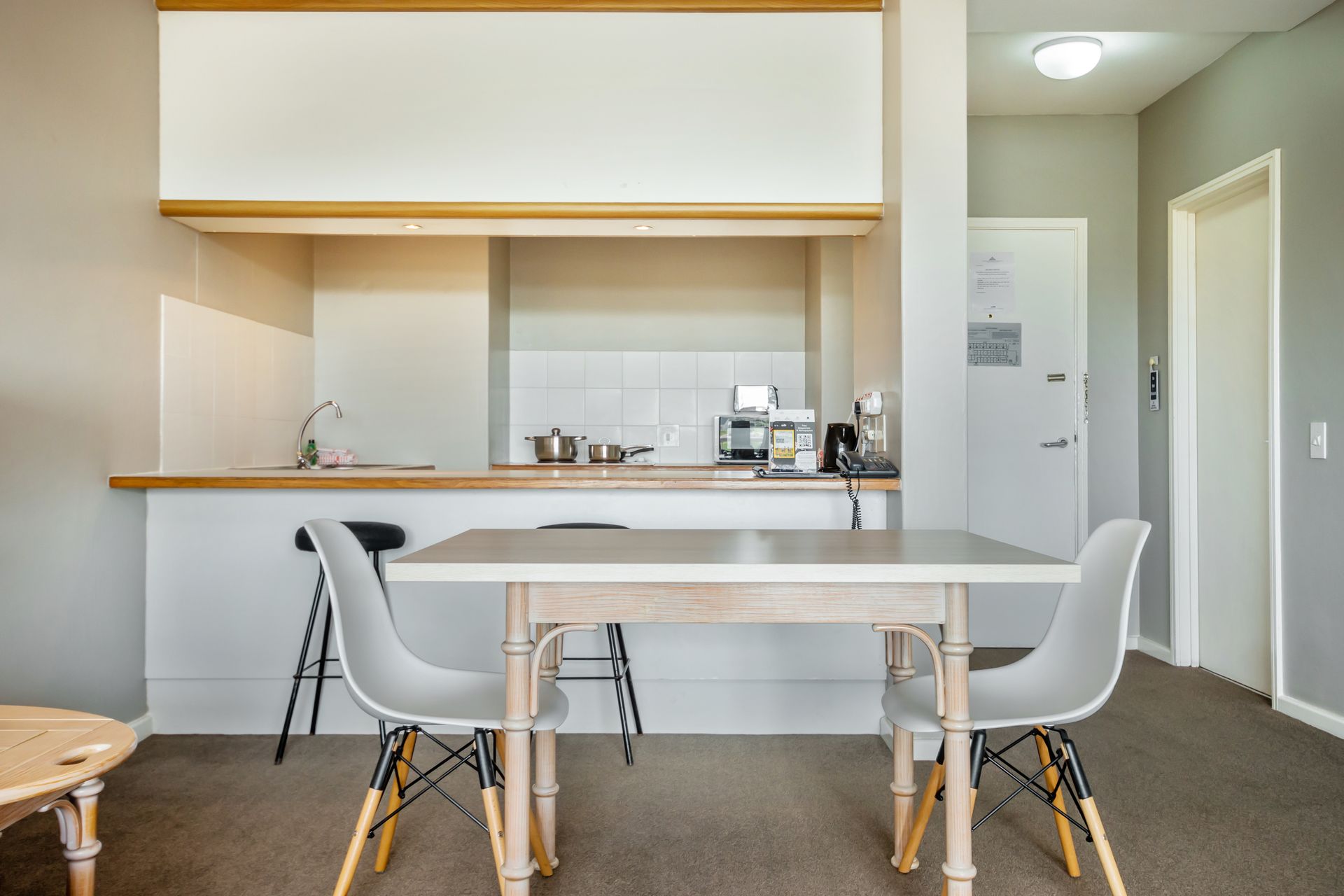 There is a table and chairs in the middle of the room.