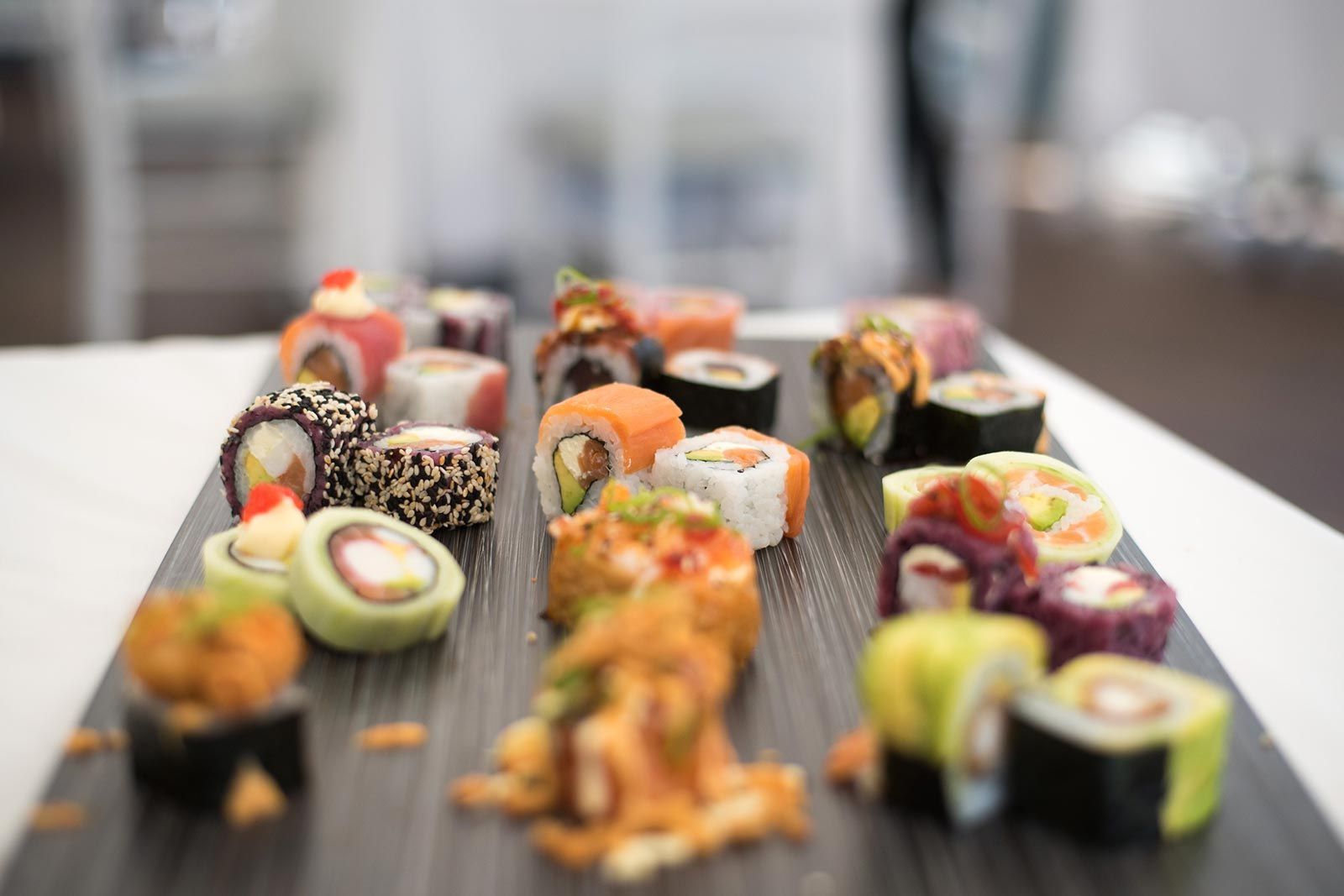 A tray of sushi is sitting on a table.