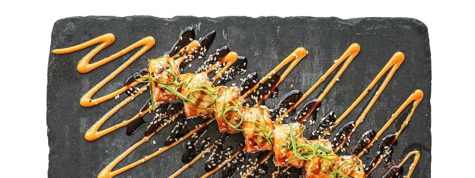 A close up of a plate of food on a slate cutting board.