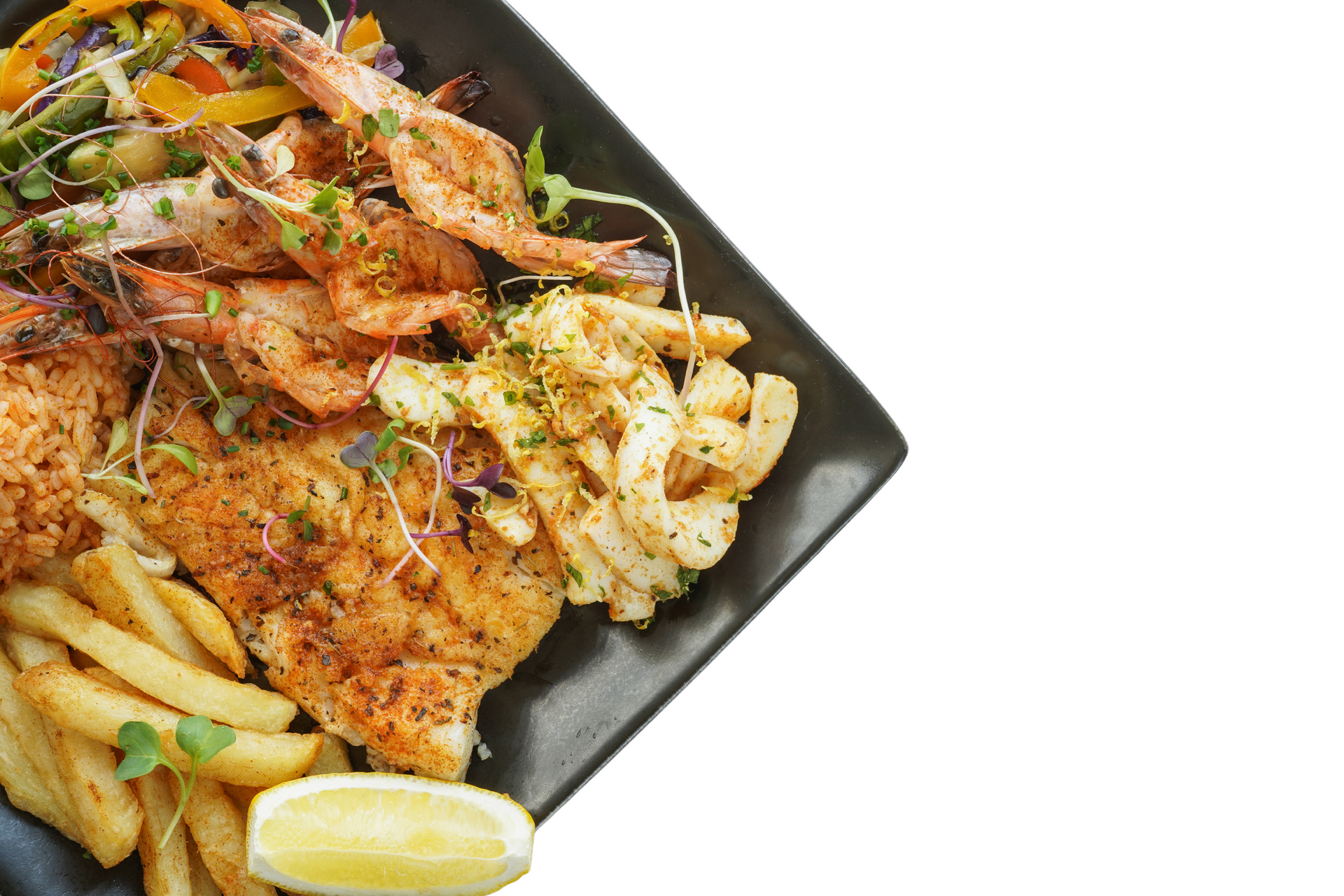 A black plate topped with fish , shrimp , french fries and vegetables.