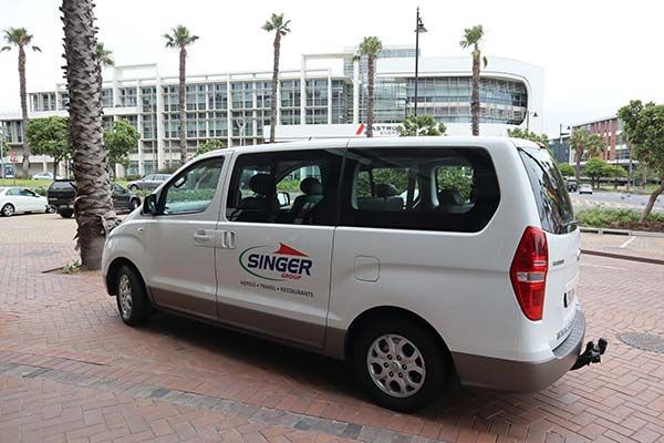 A white van with the word singer on the side