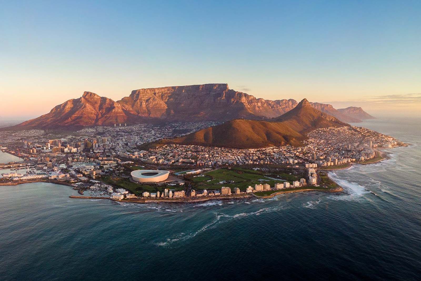 An aerial view of cape town with a mountain in the background.