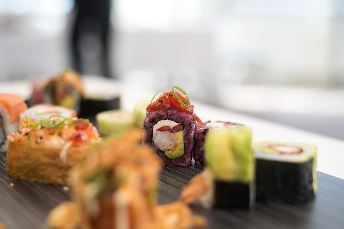 A close up of a plate of sushi on a table.