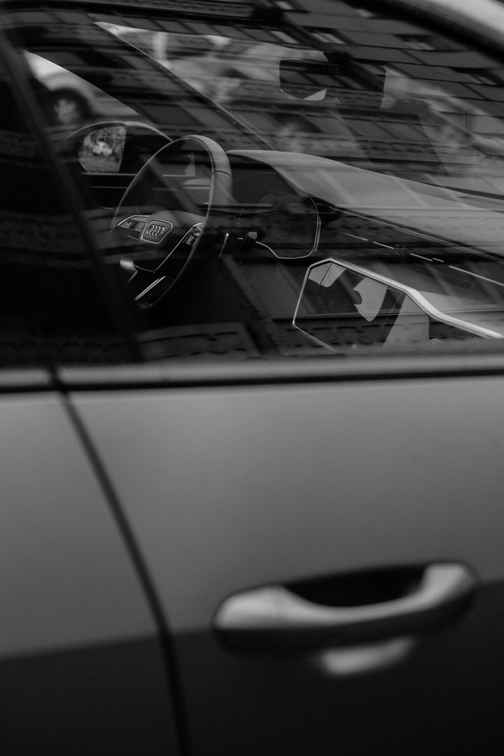 A black and white photo of the inside of a car.