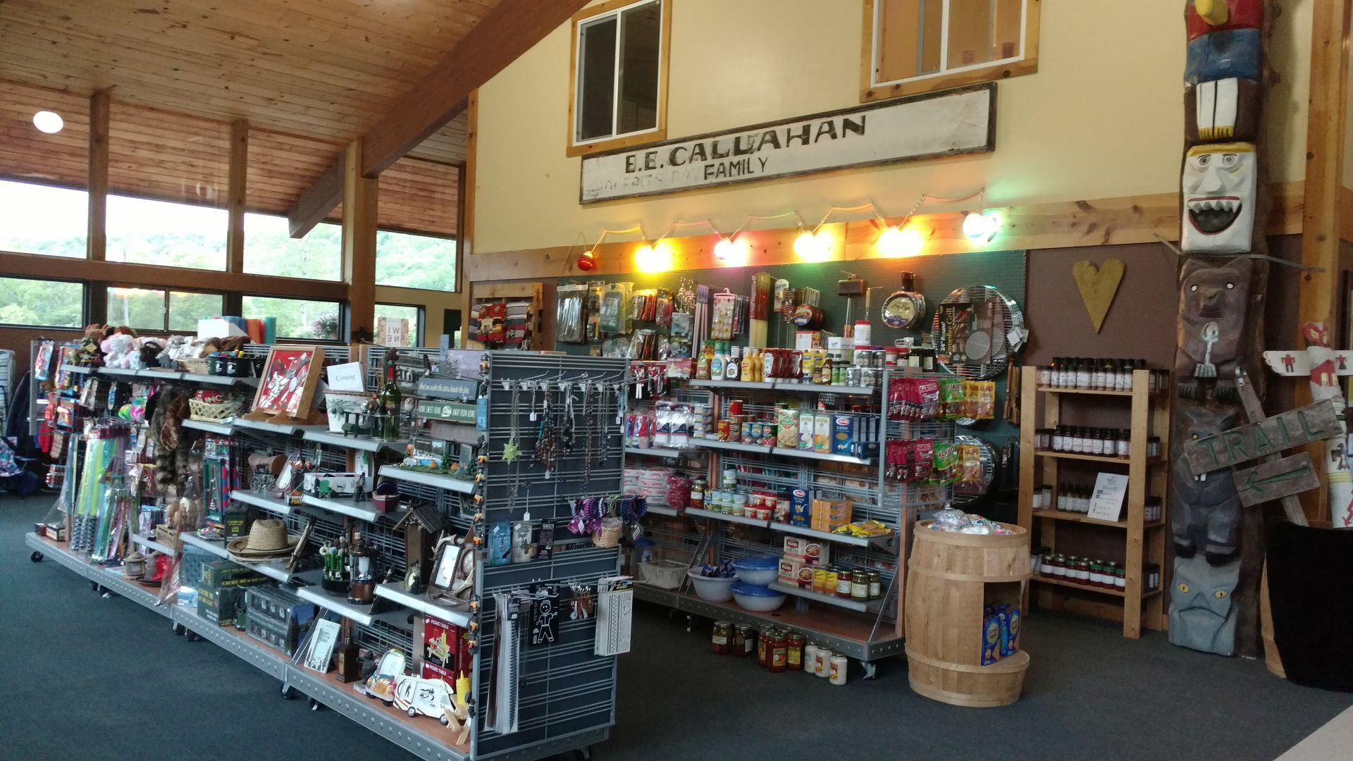 Gift shop interior with shelves of items. Sign: 