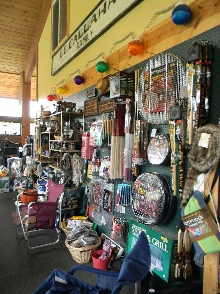 Inside a store, display of camping and grilling supplies.