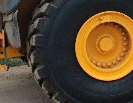 The tires of a semi truck are stacked on top of each other.