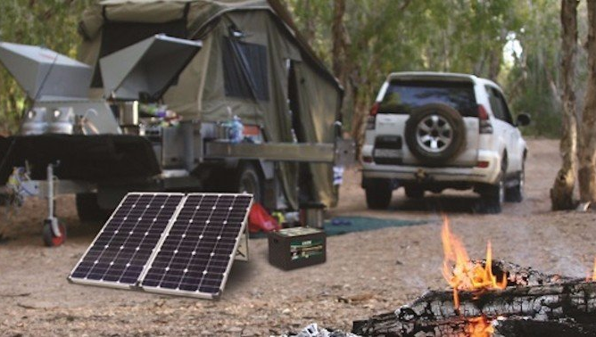 4WD camping setup with portable solar panel and deep-cycle battery