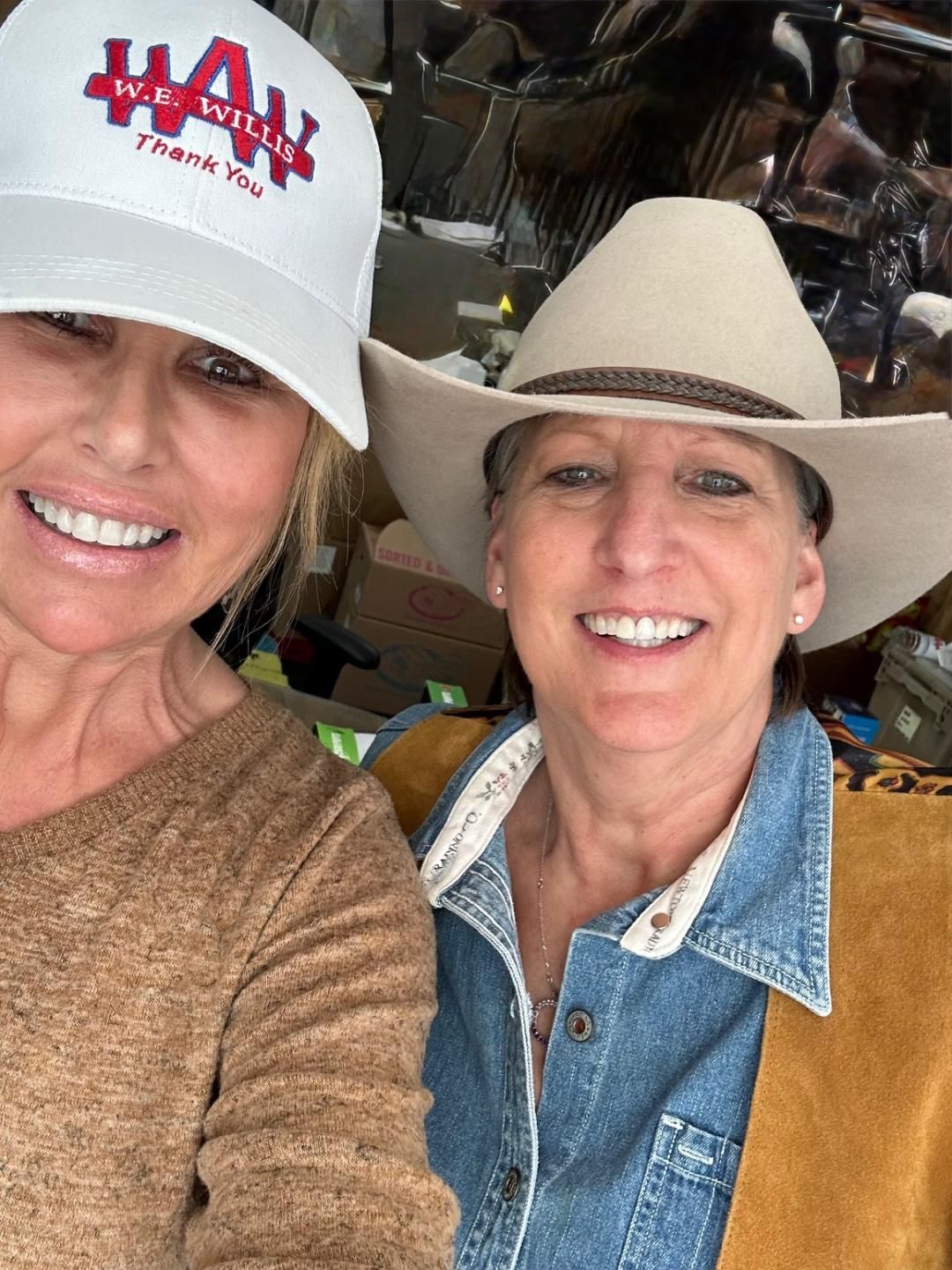 A man wearing sunglasses is holding a bottle of water.