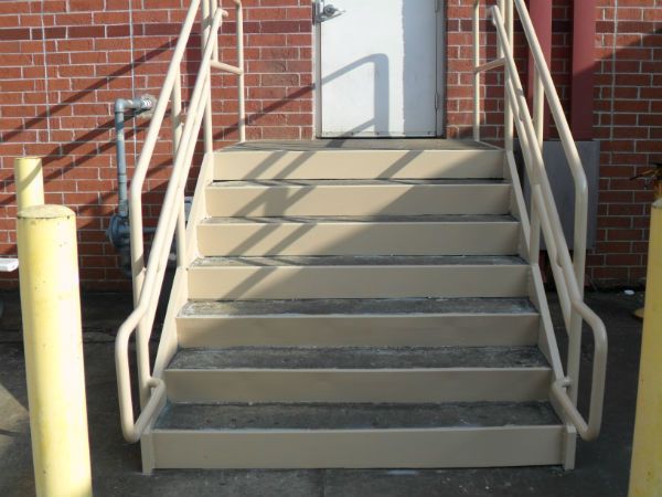 A set of stairs leading up to a brick building