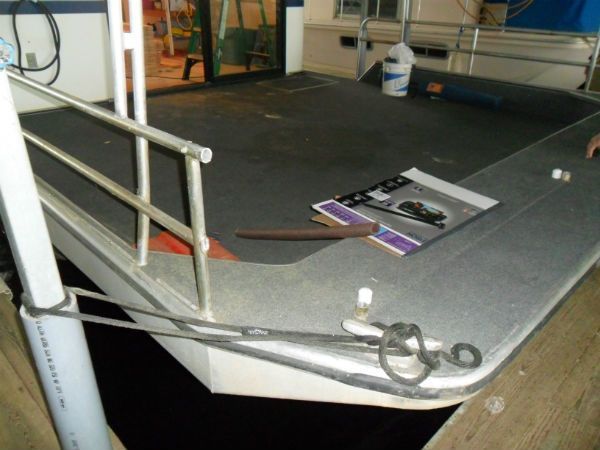 A boat with a railing and a book on the deck
