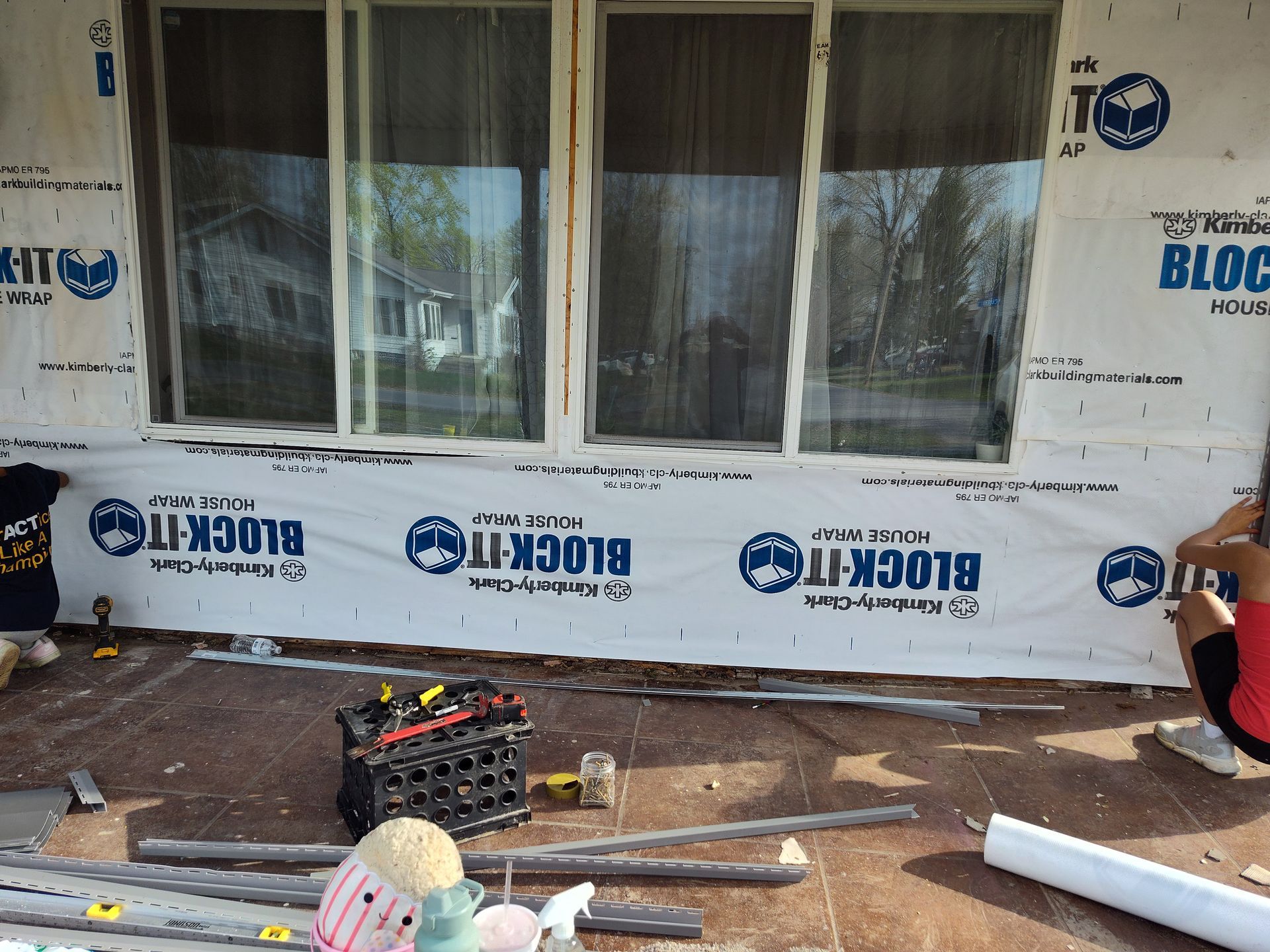 A person is sitting in front of a window with block-it written on it