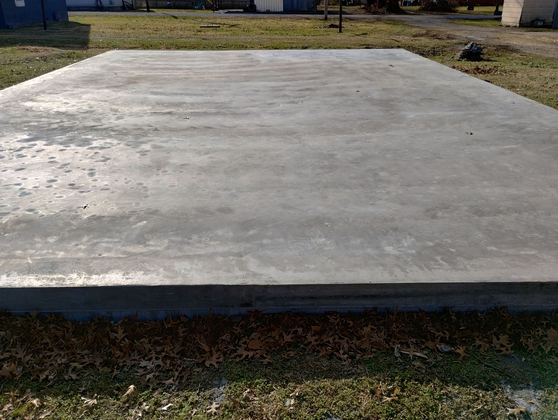 A large concrete slab is sitting on top of a lush green field.