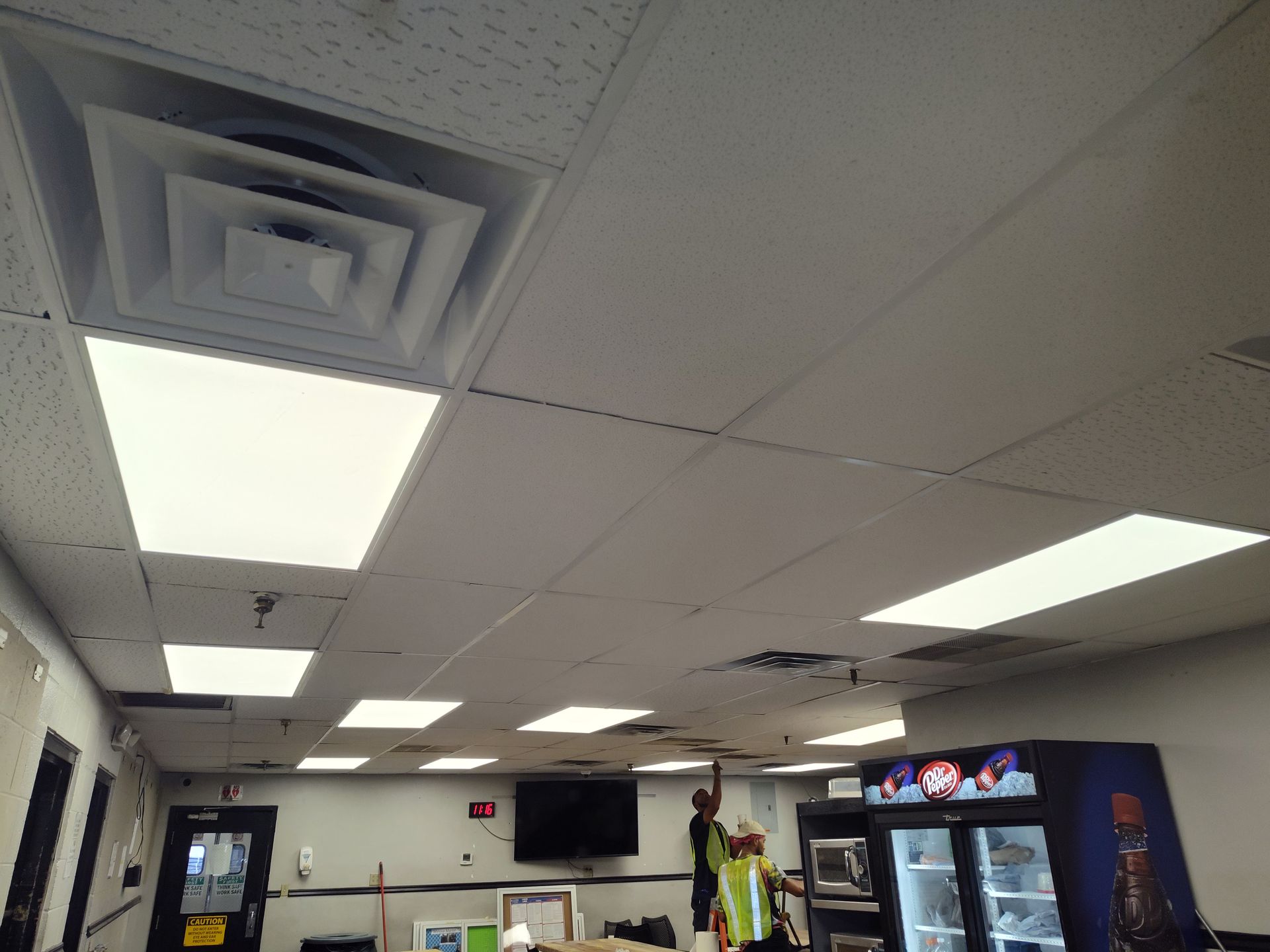 A man is working on the ceiling of a restaurant