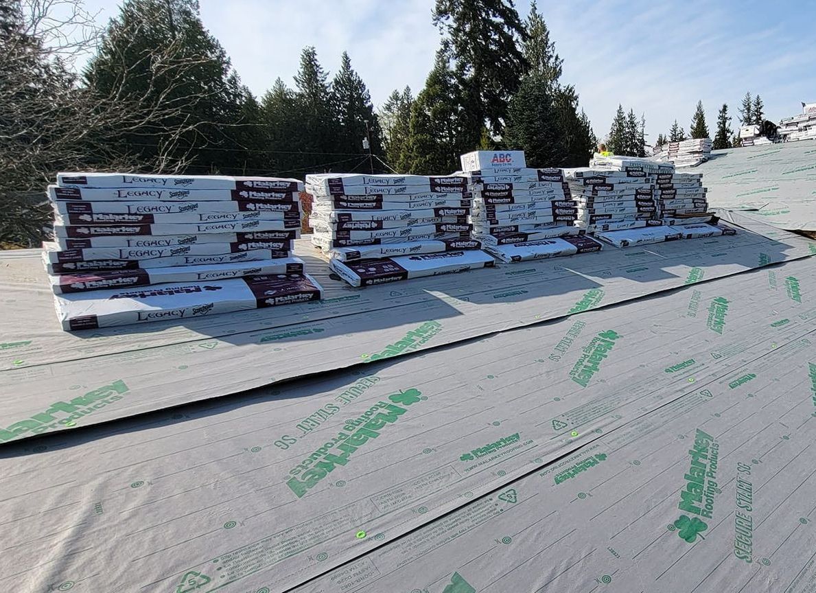 A roof with a lot of roofing material on it from Washington Roofing Services near Arlington WA