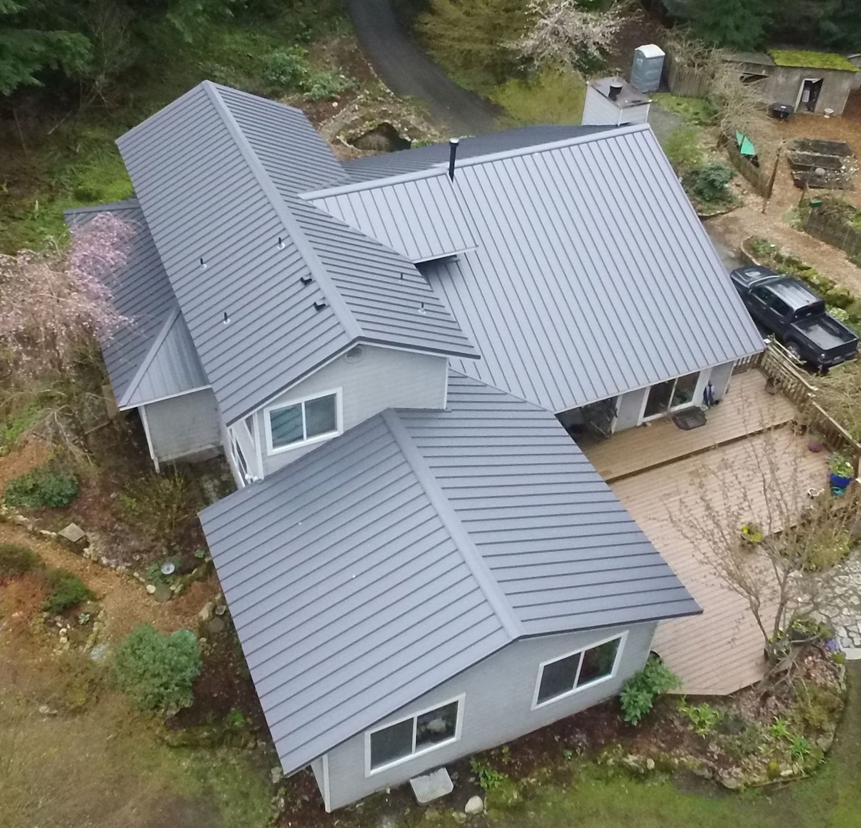 An aerial view of a house with a metal roof from Washington Roofing Services near Arlington WA