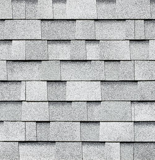 A close up of a row of white shingles on a roof.