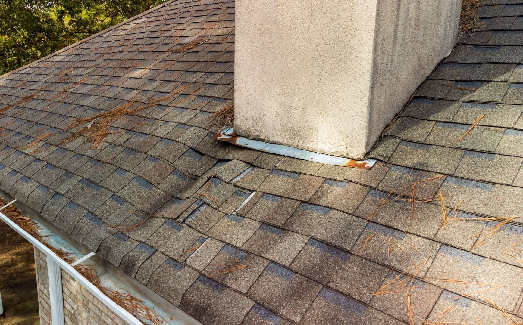 There is a chimney on the roof of a house that needs repair image from Washington Roofing Services near Arlington WA
