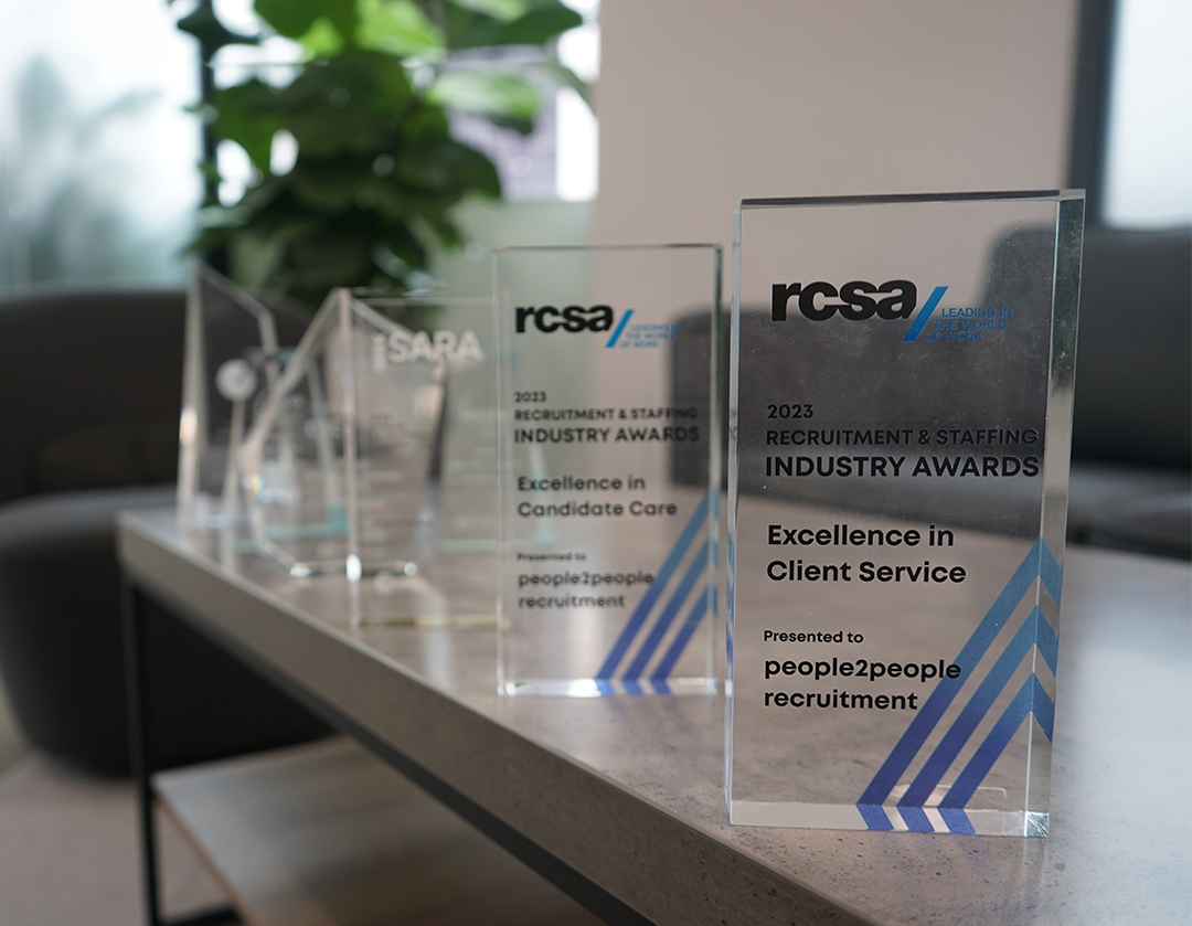 A row of awards are sitting on a table.