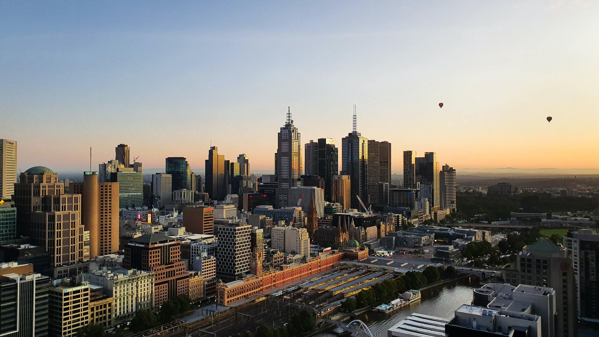 An aerial view of a city skyline at sunset