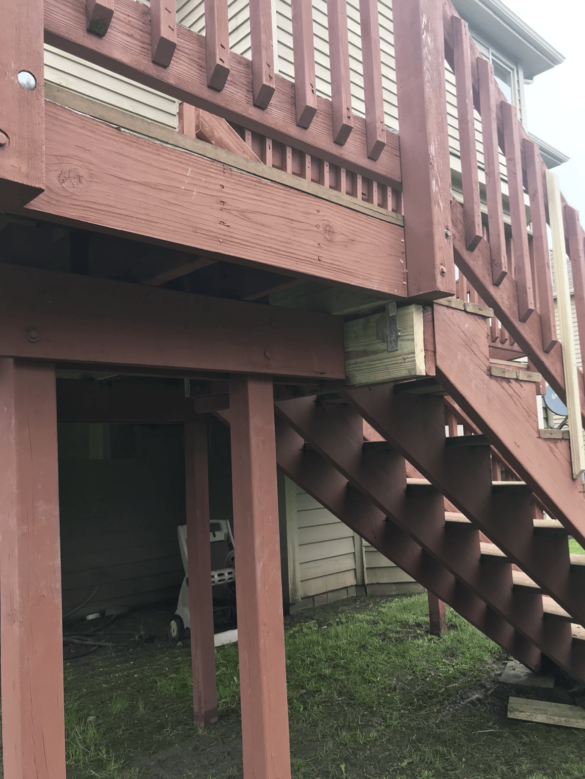 A wooden deck with stairs leading up to it.