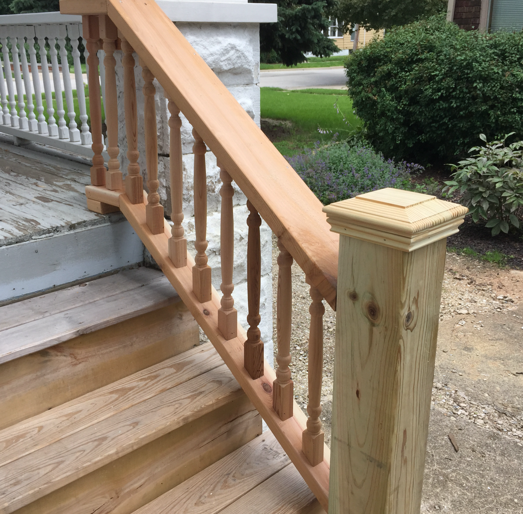 A wooden railing on a set of stairs