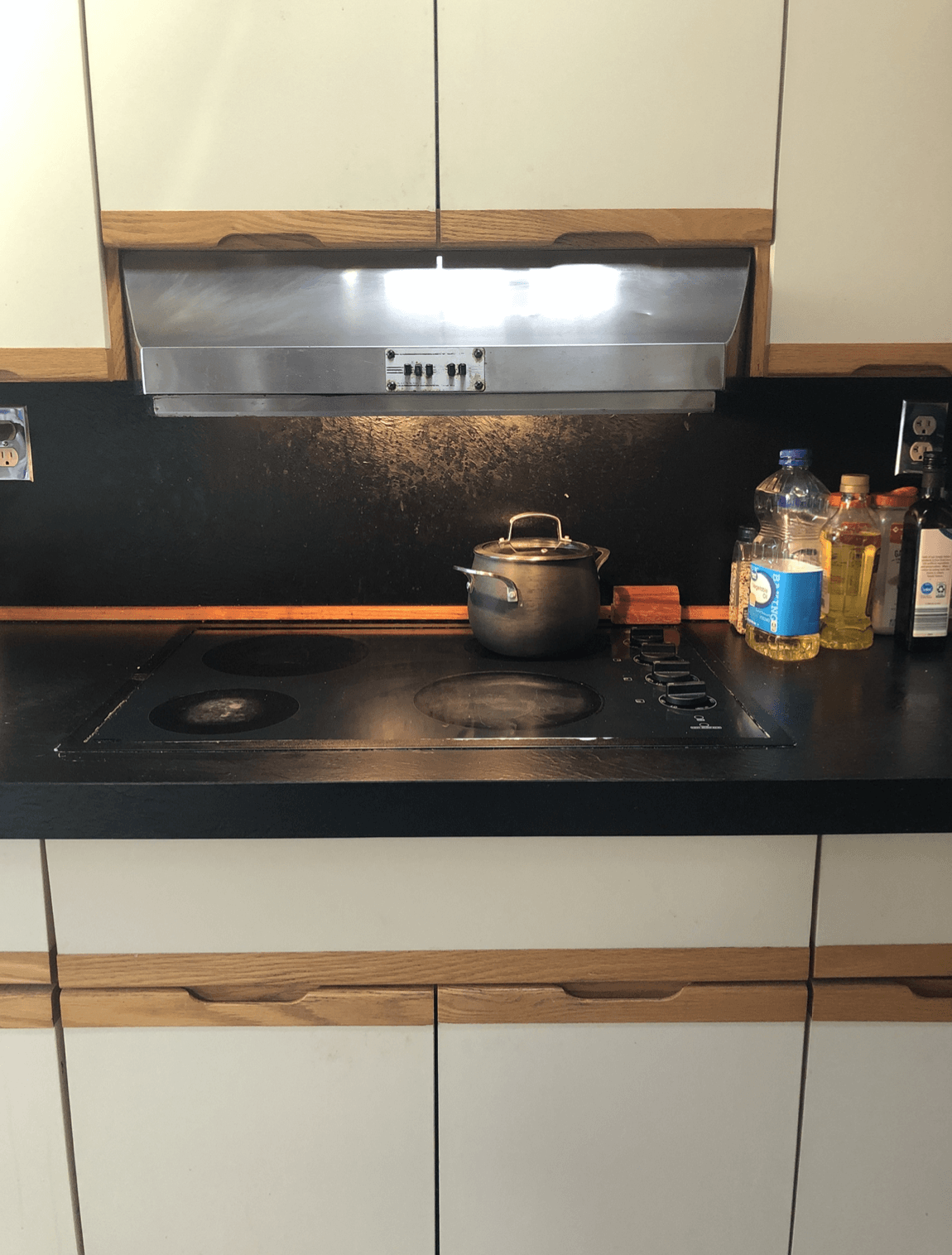 A kitchen counter with a pot on top of it