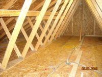 The attic of a house is being built with wooden beams.